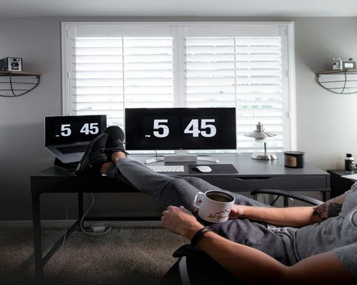 Person doing light stretching near a home office desk