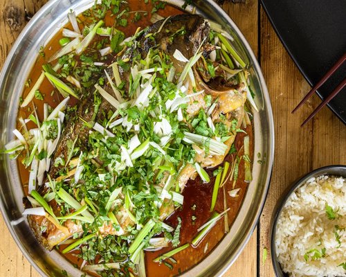 Steamed whole fish with Thai herbs and soy sauce